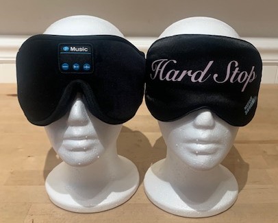 black silk eyemask and wireless headphones